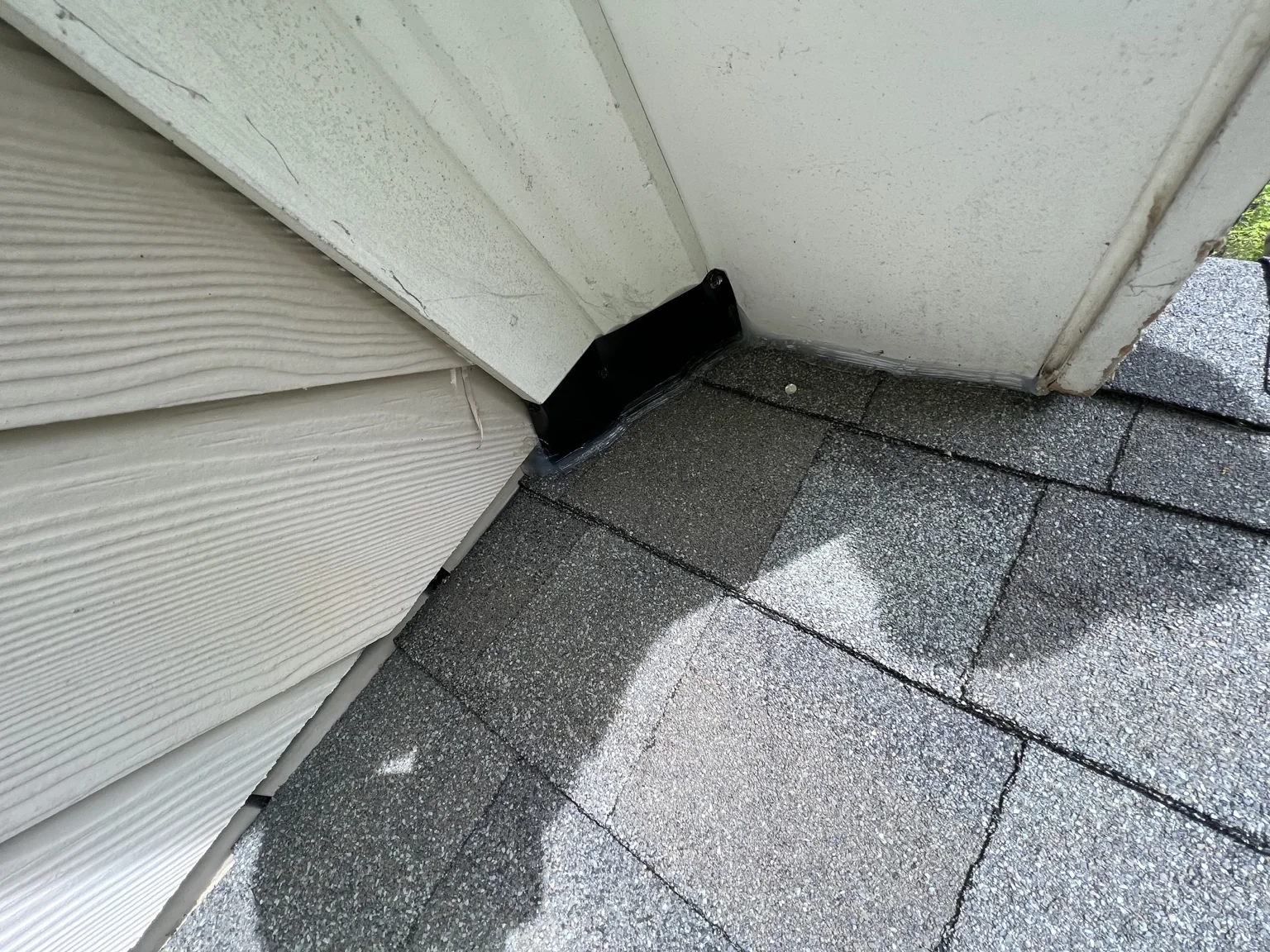 Metal patch and sealant at a roof-to-soffit entry point